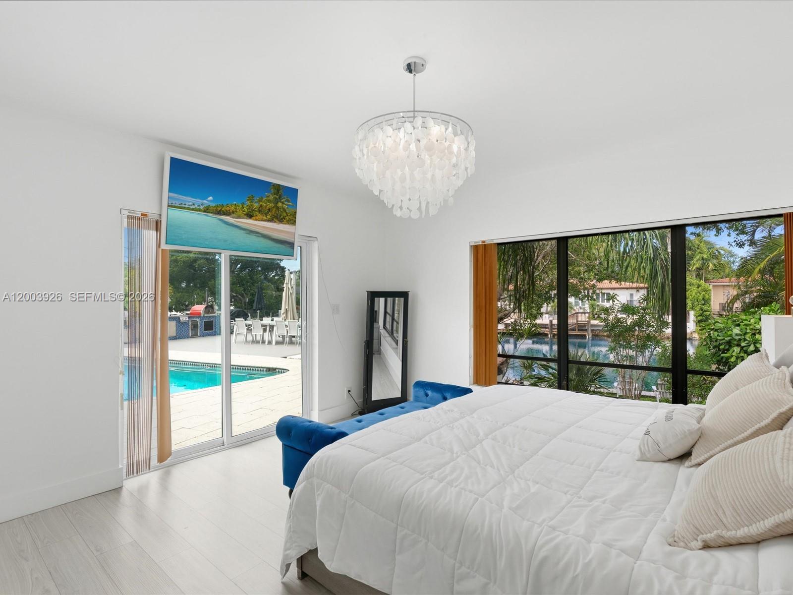 5000 Riviera Drive Coral Gables, FL 33146 - Photo 32 of 80 a bedroom with a large bed and a large window