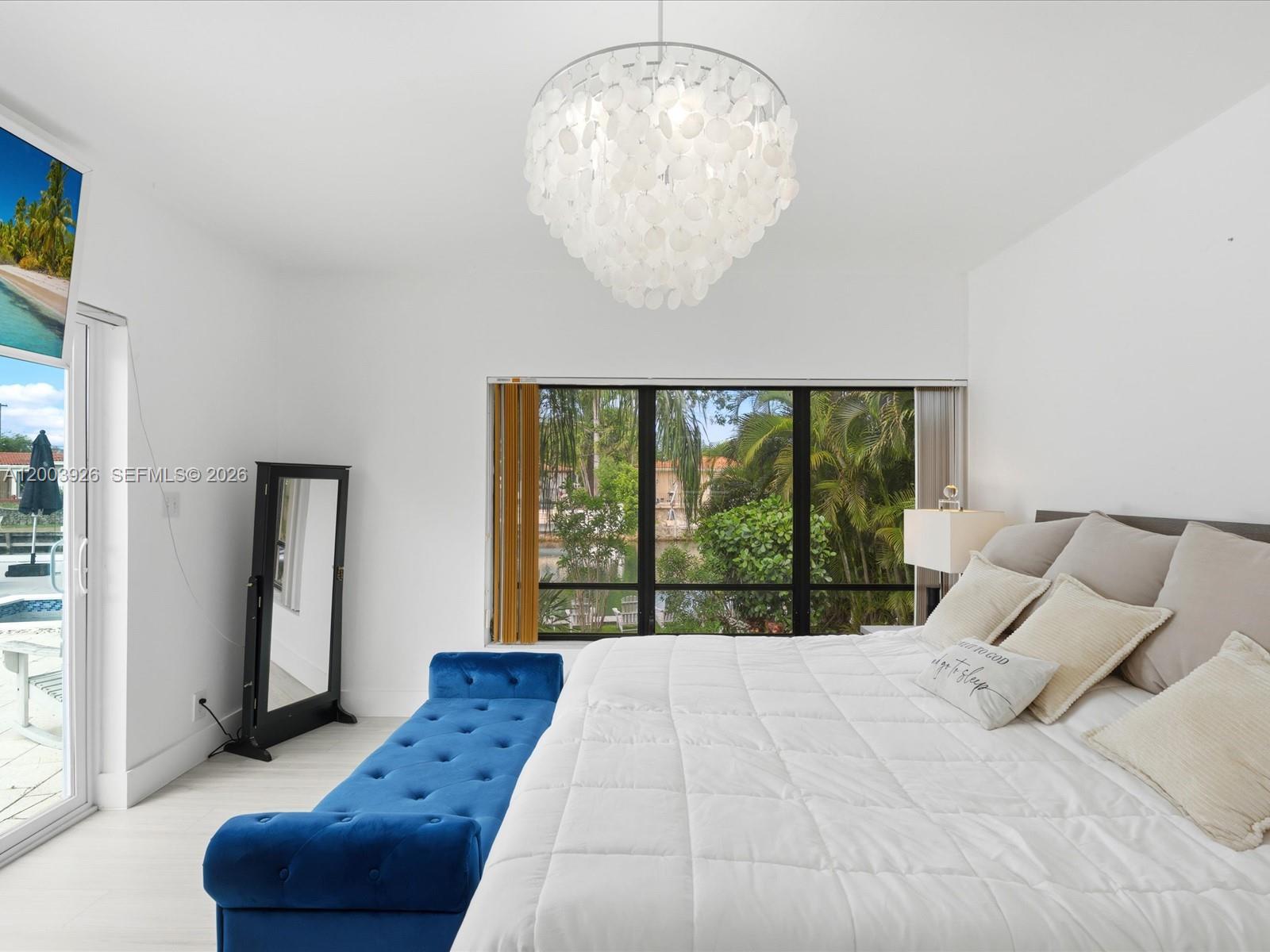 5000 Riviera Drive Coral Gables, FL 33146 - Photo 35 of 80 a bedroom with a large bed and a large window