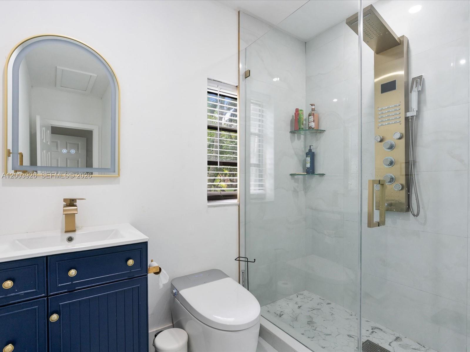 5000 Riviera Drive Coral Gables, FL 33146 - Photo 44 of 80 a bathroom with a toilet a sink and shower