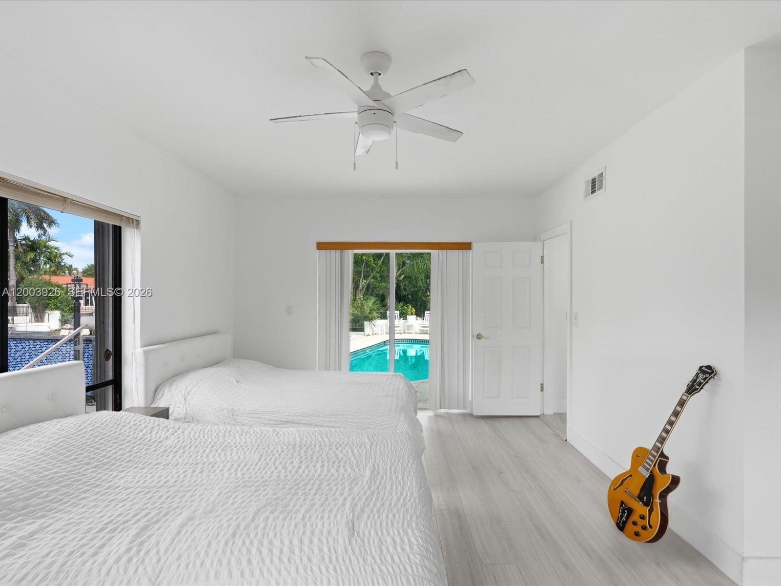 5000 Riviera Drive Coral Gables, FL 33146 - Photo 47 of 80 a bedroom with a bed and a window