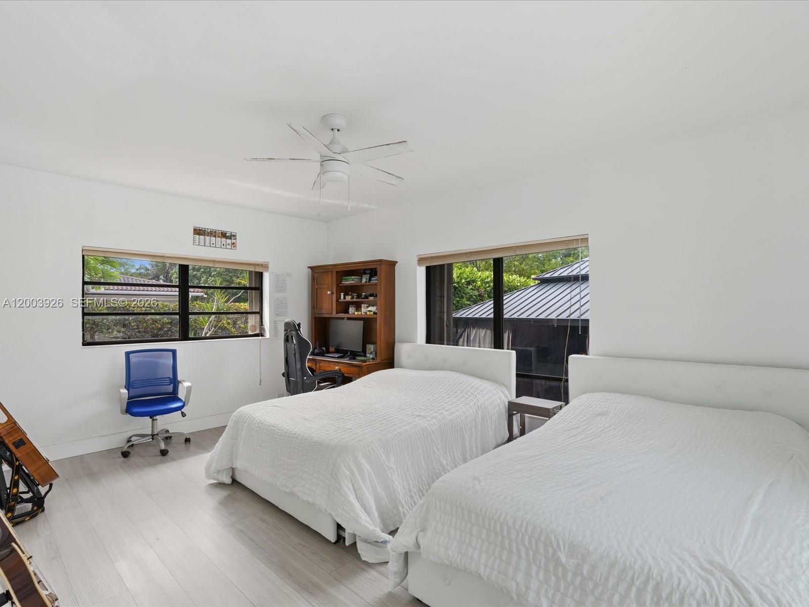 5000 Riviera Drive Coral Gables, FL 33146 - Photo 48 of 80 a bedroom with two beds and a desk