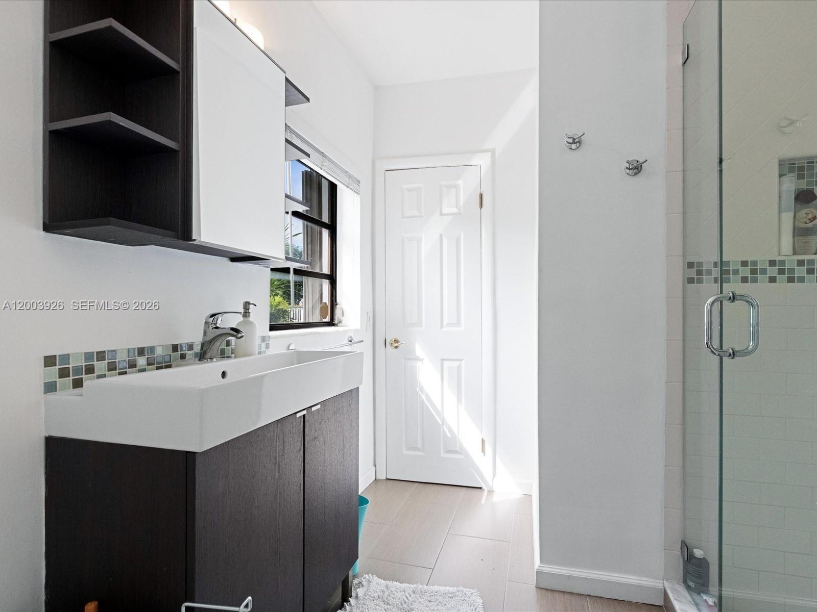 5000 Riviera Drive Coral Gables, FL 33146 - Photo 50 of 80 a bathroom with a sink vanity and mirror