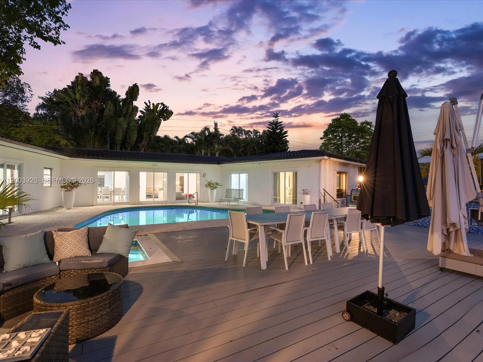 5000 Riviera Drive Coral Gables, FL 33146 - Photo 6 of 80 a view of deck with table and chairs with wooden floor and fence