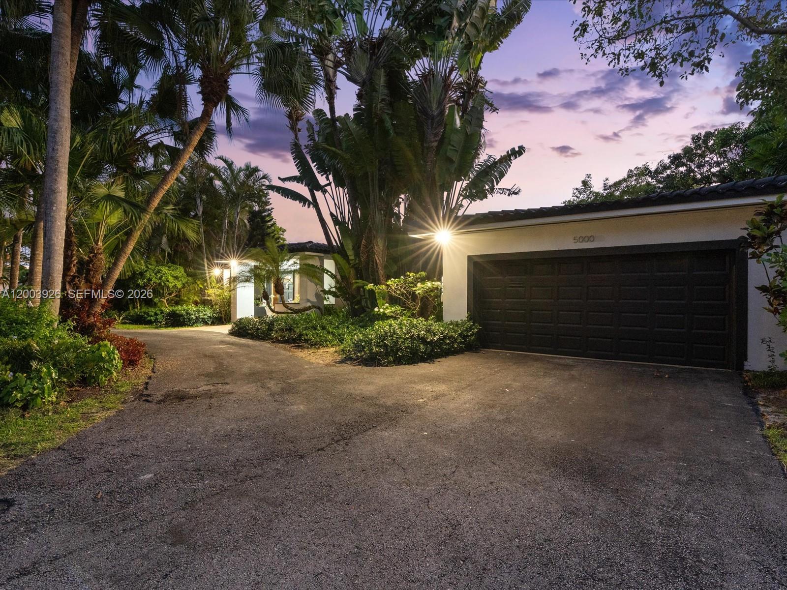 5000 Riviera Drive Coral Gables, FL 33146 - Photo 70 of 80 a view of a house with a yard and garage