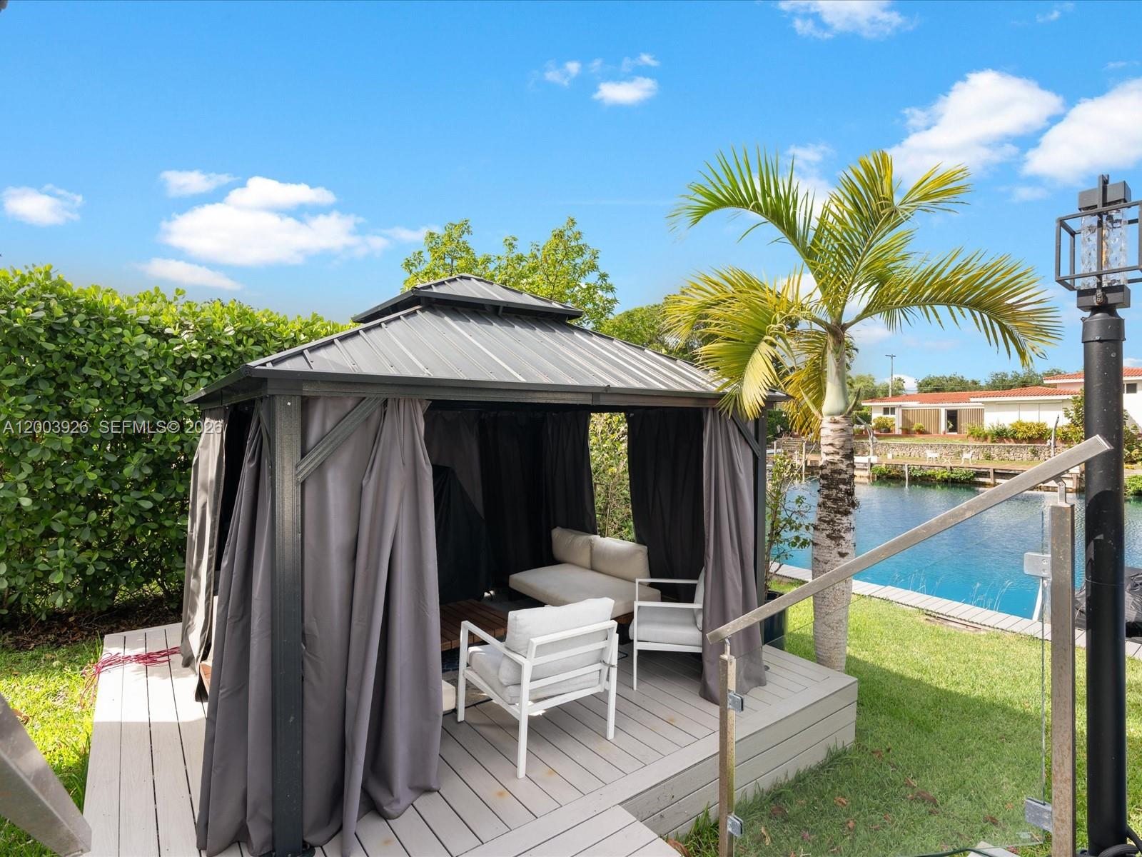 5000 Riviera Drive Coral Gables, FL 33146 - Photo 74 of 80 a view of a patio with couches table and chairs and potted plants