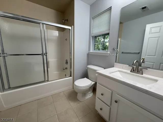 a bathroom with a sink toilet and window