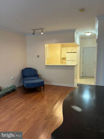 a kitchen with a refrigerator sink and cabinets