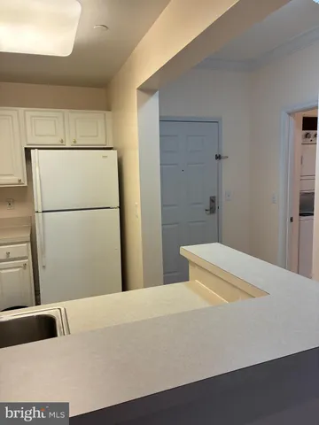 a view of a room with wooden floor and lounge chairs