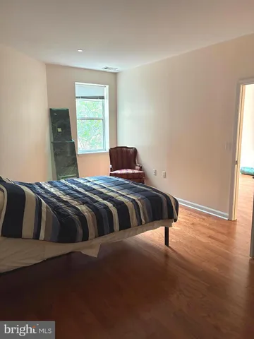 a room with a wooden floor and cabinets