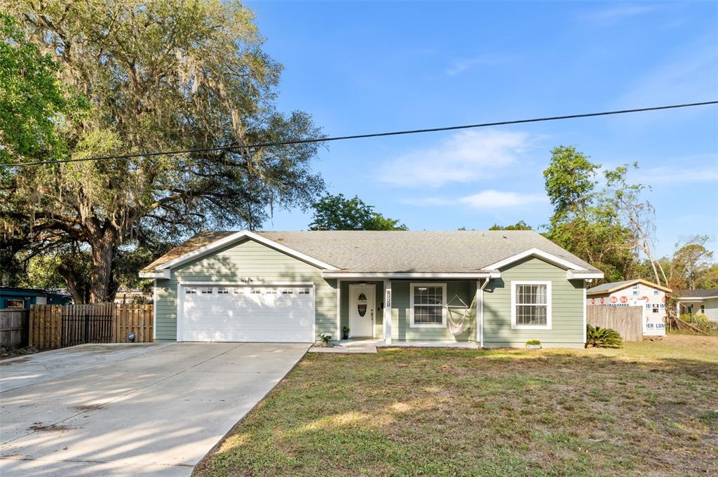 4928 Southwest 63rd Lane Gainesville, FL 32608 - Photo 1 of 32 a front view of a house with a yard and garage