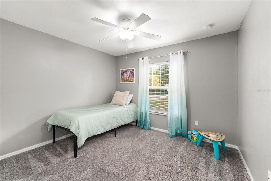 4928 Southwest 63rd Lane Gainesville, FL 32608 - Photo 21 of 32 a spacious bedroom with a bed and a window