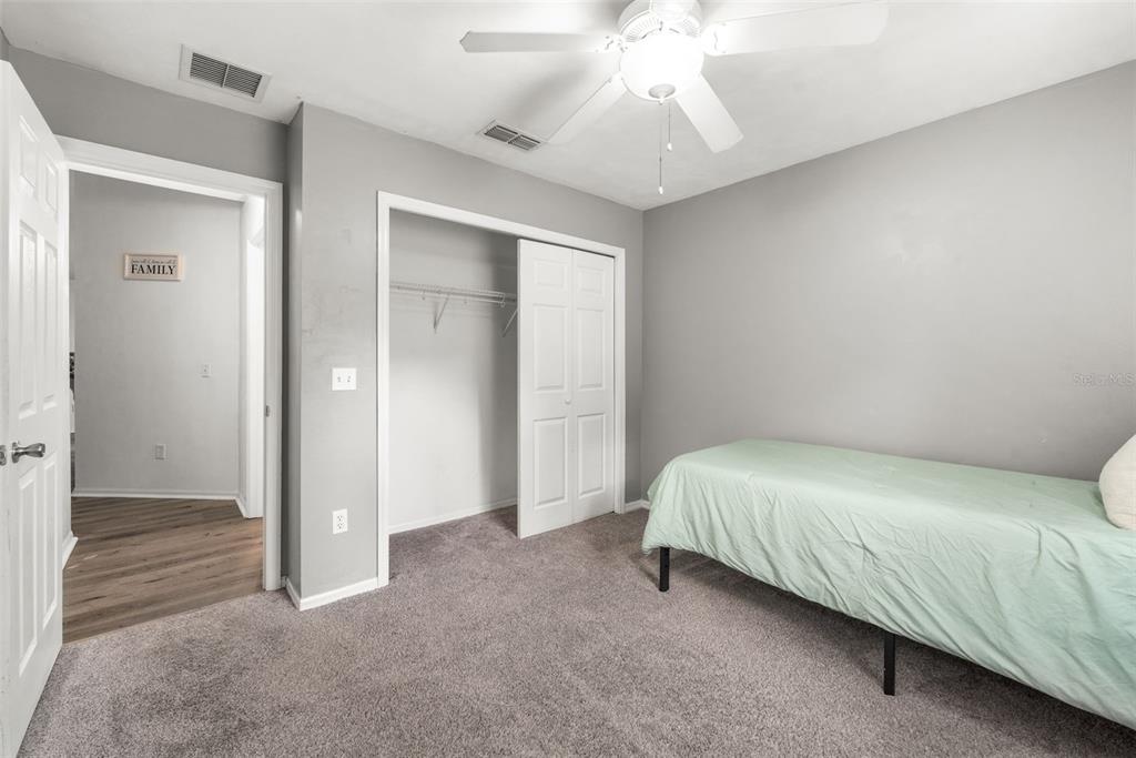 4928 Southwest 63rd Lane Gainesville, FL 32608 - Photo 22 of 32 a bedroom with a bed and a chandelier