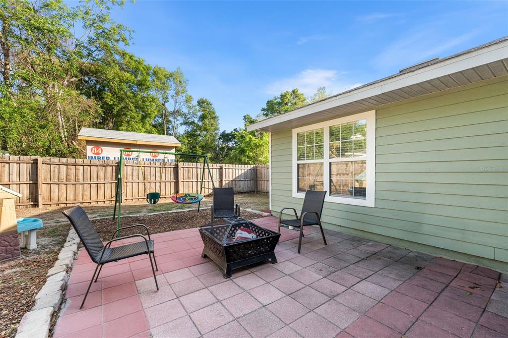 4928 Southwest 63rd Lane Gainesville, FL 32608 - Photo 28 of 32 a building outdoor space with patio furniture and potted plants