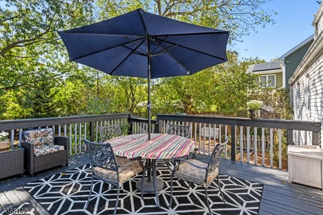 a view of a balcony with furniture and wooden floor