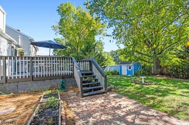 a view of a house with backyard and wooden fence