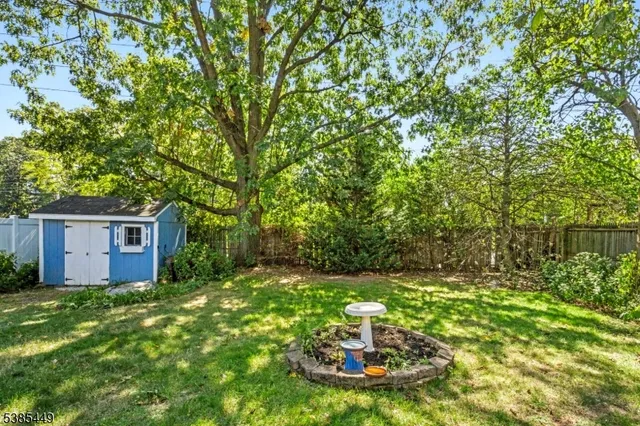 a view of a house with backyard sitting area and garden