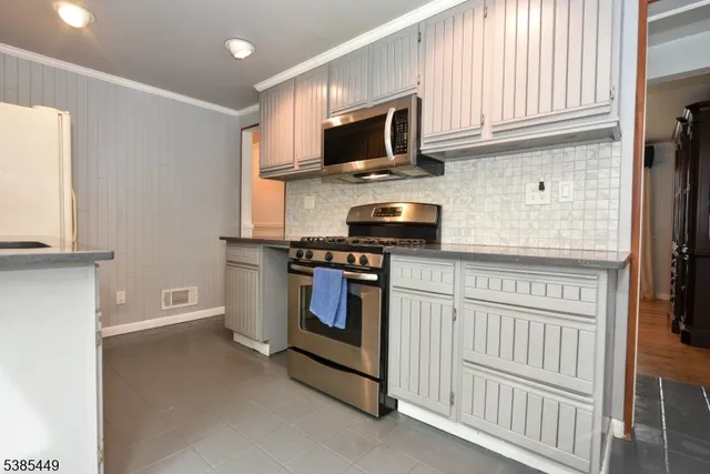 a kitchen with stainless steel appliances a stove microwave and a refrigerator