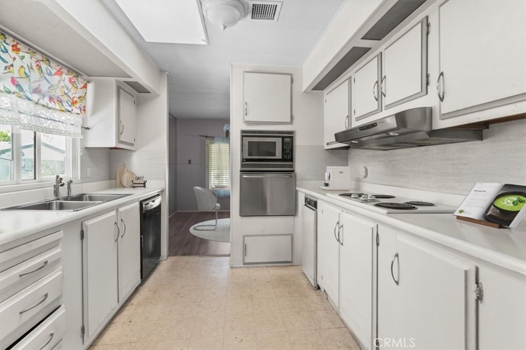 14851 Jeffrey Road, Unit 248 Irvine, CA 92618 - Photo 11 of 27 a kitchen with stainless steel appliances a sink stove and cabinets