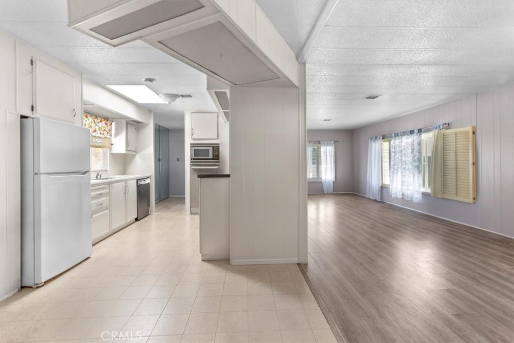 14851 Jeffrey Road, Unit 248 Irvine, CA 92618 - Photo 17 of 27 a view of a refrigerator in kitchen and wooden floor