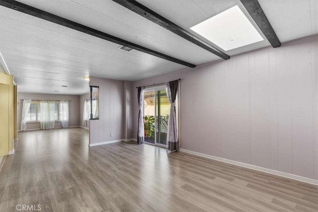 14851 Jeffrey Road, Unit 248 Irvine, CA 92618 - Photo 18 of 27 a view of an empty room with wooden floor and a window
