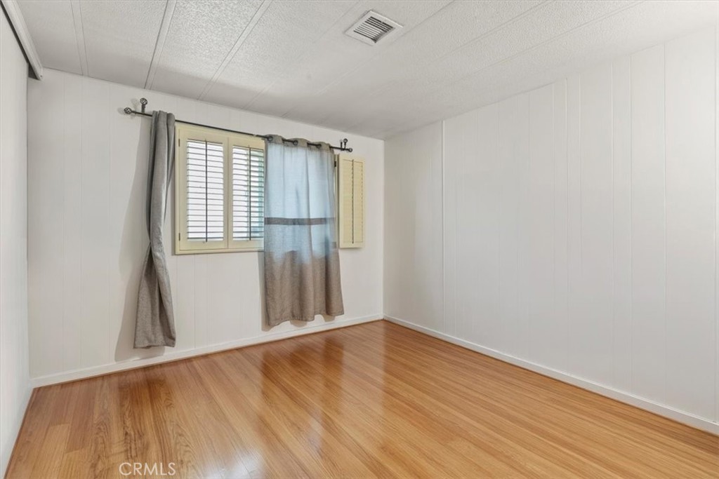 14851 Jeffrey Road, Unit 248 Irvine, CA 92618 - Photo 19 of 27 an empty room with wooden floor and windows