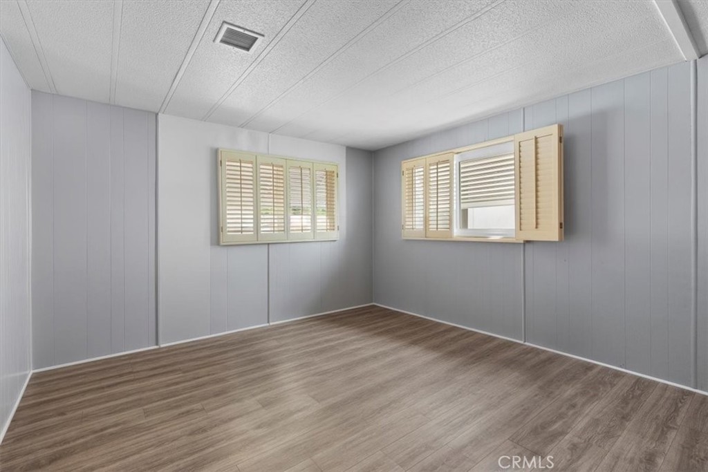 14851 Jeffrey Road, Unit 248 Irvine, CA 92618 - Photo 21 of 27 an empty room with wooden floor and windows
