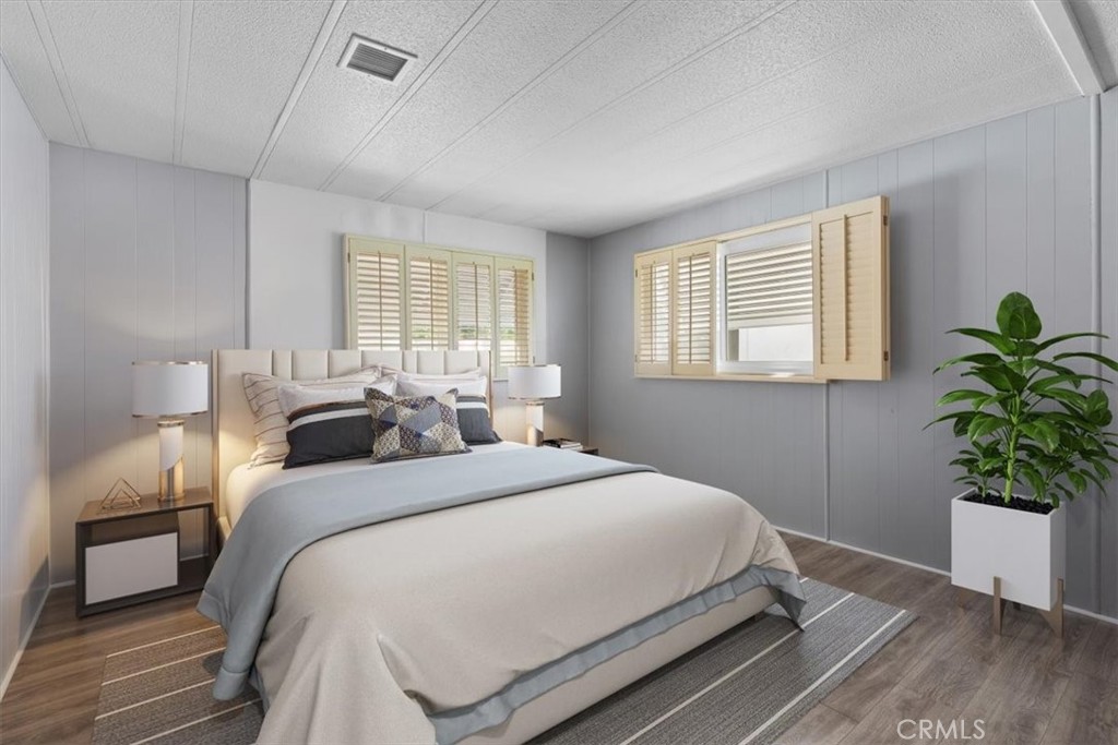 14851 Jeffrey Road, Unit 248 Irvine, CA 92618 - Photo 23 of 27 a bedroom with a bed and a potted plant