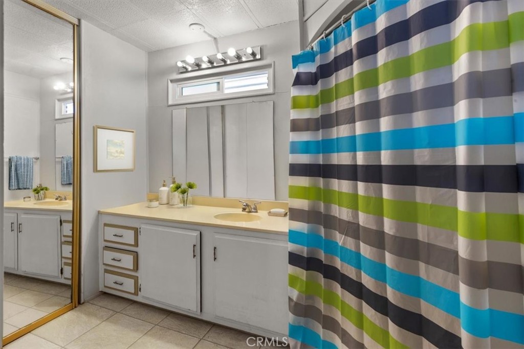 14851 Jeffrey Road, Unit 248 Irvine, CA 92618 - Photo 24 of 27 a view of a bathroom with sink and mirror
