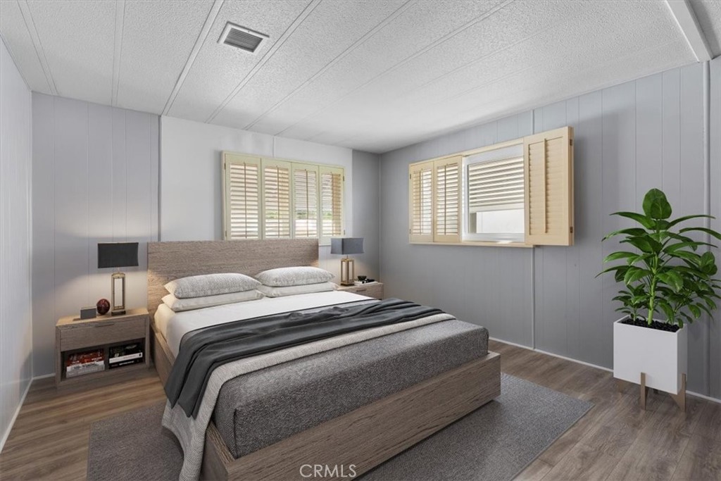 14851 Jeffrey Road, Unit 248 Irvine, CA 92618 - Photo 26 of 27 a bedroom with a bed and a potted plant