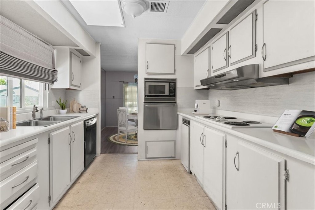 14851 Jeffrey Road, Unit 248 Irvine, CA 92618 - Photo 8 of 27 a kitchen with white cabinets and appliances