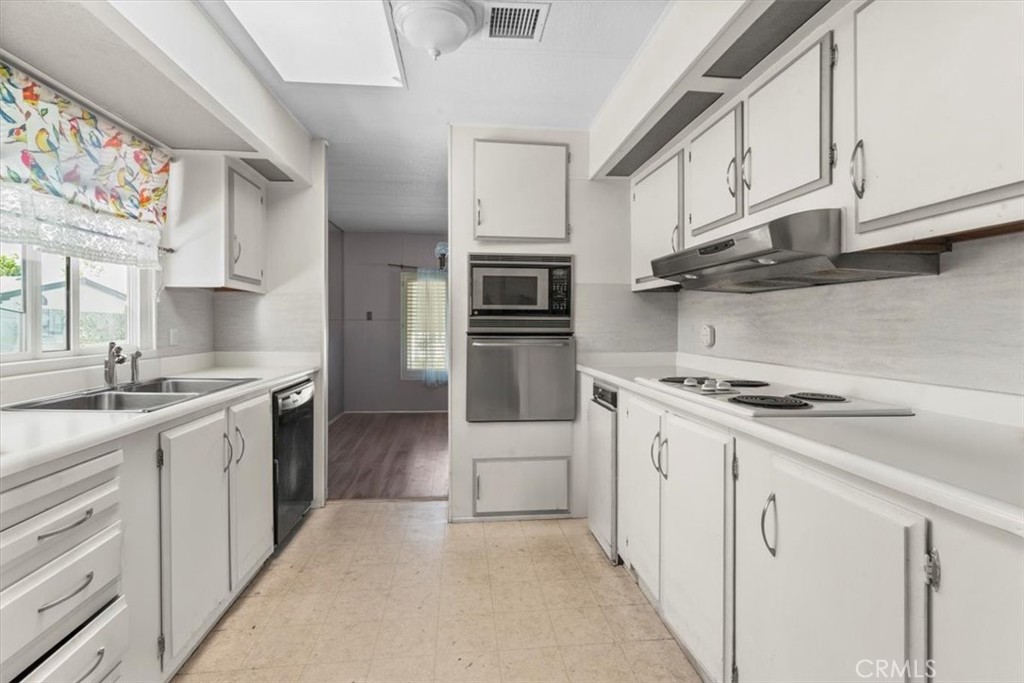 14851 Jeffrey Road, Unit 248 Irvine, CA 92618 - Photo 9 of 27 a kitchen with stainless steel appliances granite countertop a stove and a refrigerator