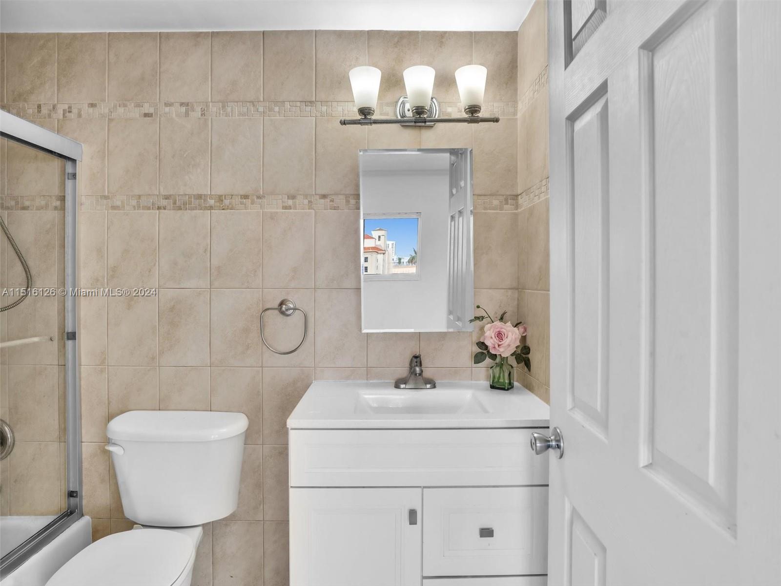 320 South Surf Road, Unit 705 Hollywood, FL 33019 - Photo 12 of 29 a bathroom with a toilet sink and shower