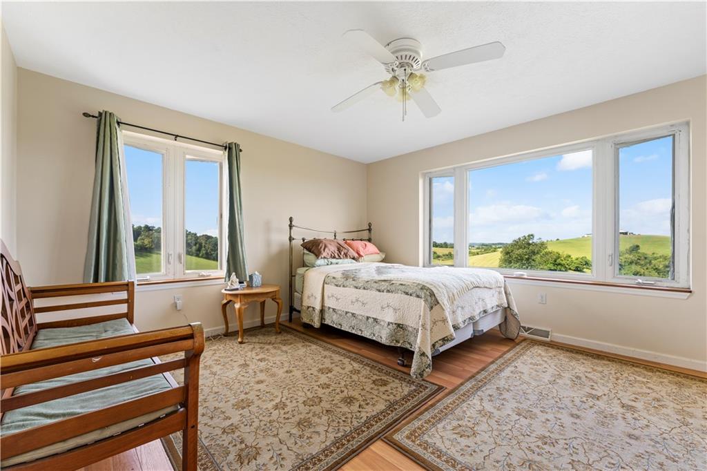 321 Chambers Ridge Road West Alexander, PA 15376 - Photo 18 of 42 a bed room with a bed and a chandelier