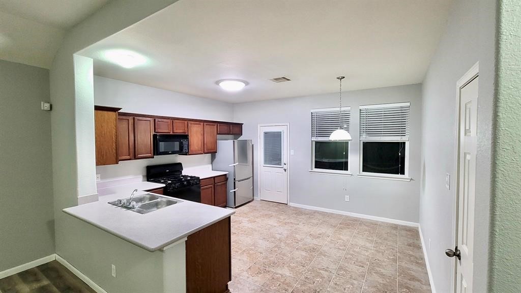 23614 Maple View Drive Spring, TX 77373 - Photo 11 of 23 a kitchen that has a sink and a stove
