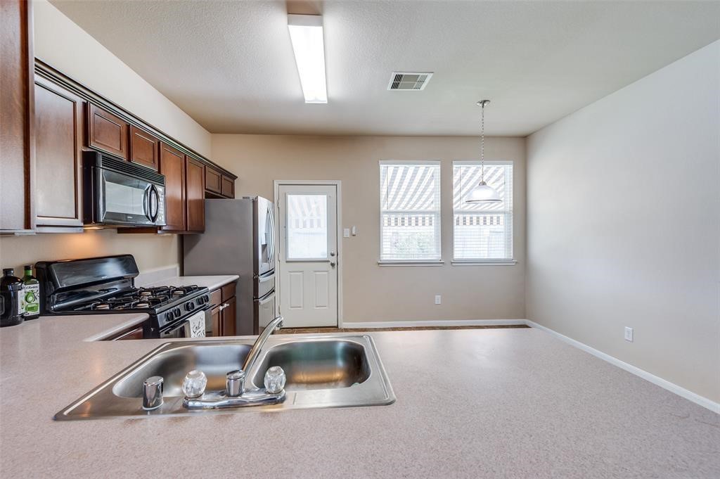 23614 Maple View Drive Spring, TX 77373 - Photo 12 of 23 a kitchen that has a sink and a stove top oven