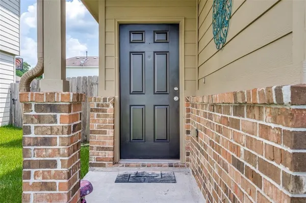 a view of a door and brick wall