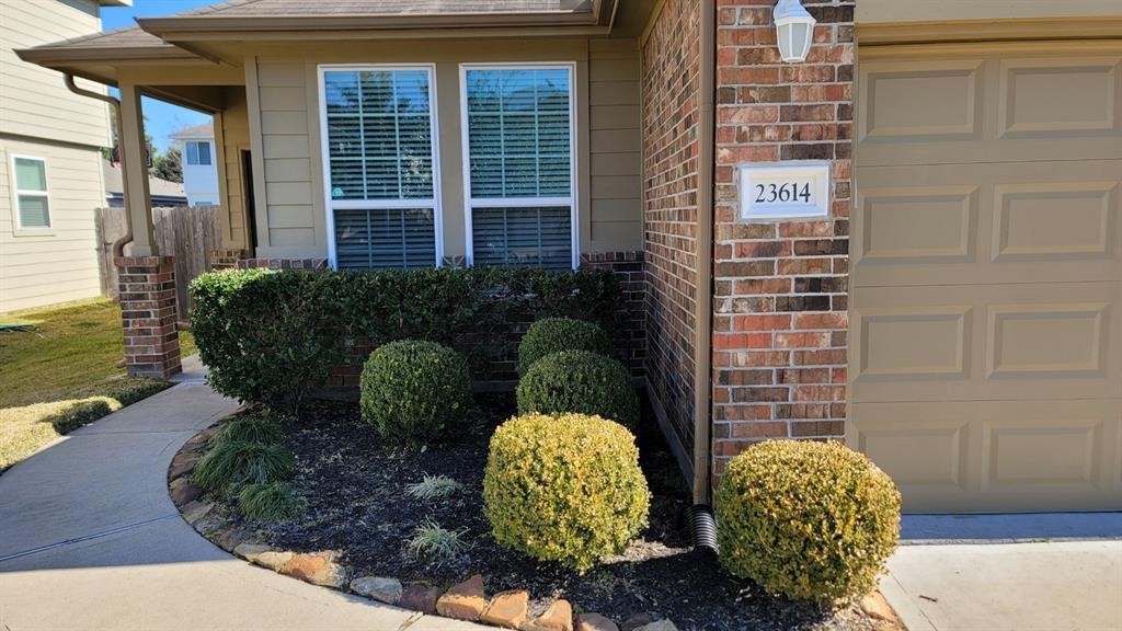 23614 Maple View Drive Spring, TX 77373 - Photo 3 of 23 a couple of potted plants sitting in front of a door