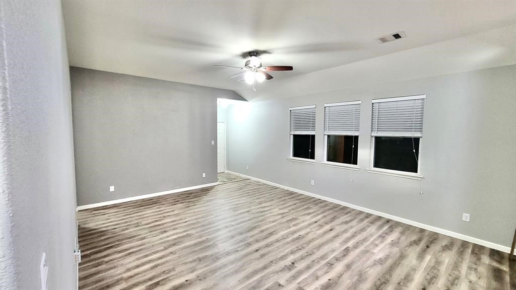 23614 Maple View Drive Spring, TX 77373 - Photo 5 of 23 a view of an empty room with window and wooden floor