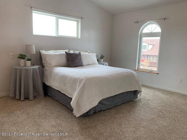 777 East 18th Street Rifle, CO 81650 - Photo 8 of 25 a bed sitting in a bedroom next to a window