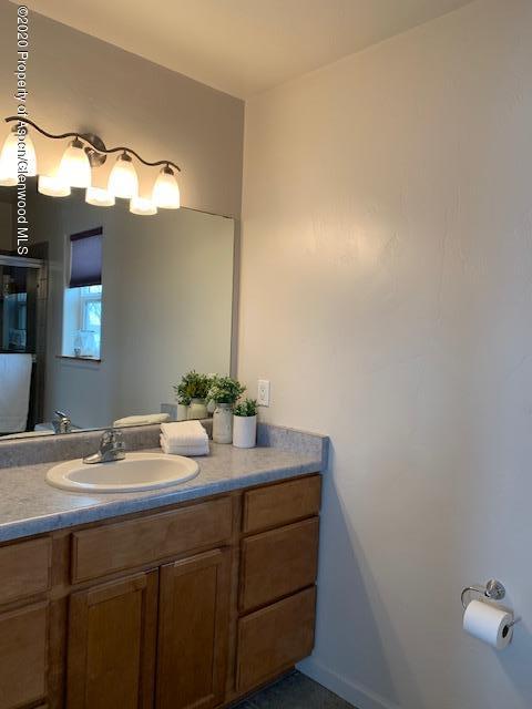 777 East 18th Street Rifle, CO 81650 - Photo 9 of 25 a bathroom with a sink and a mirror