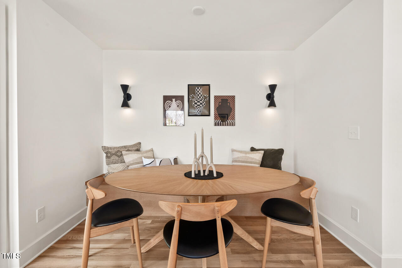1407 Carroll Street Durham, NC 27707 - Photo 16 of 48 a view of a dining room with furniture and wooden floor