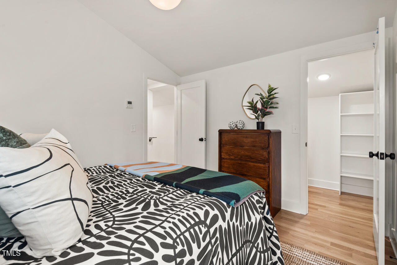 1407 Carroll Street Durham, NC 27707 - Photo 30 of 48 a bedroom with a bed and wooden floor