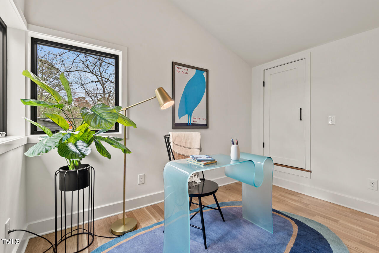 1407 Carroll Street Durham, NC 27707 - Photo 36 of 48 a view of a workspace with furniture and a potted plant