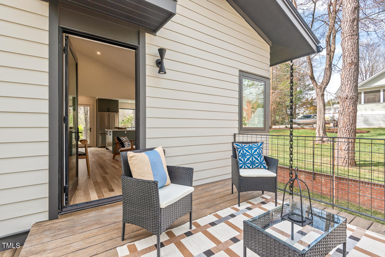 1407 Carroll Street Durham, NC 27707 - Photo 41 of 48 a view of a patio with a dining table and chairs with wooden floor and fence
