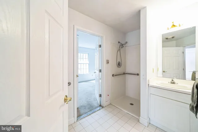 a bathroom with a shower sink and mirror
