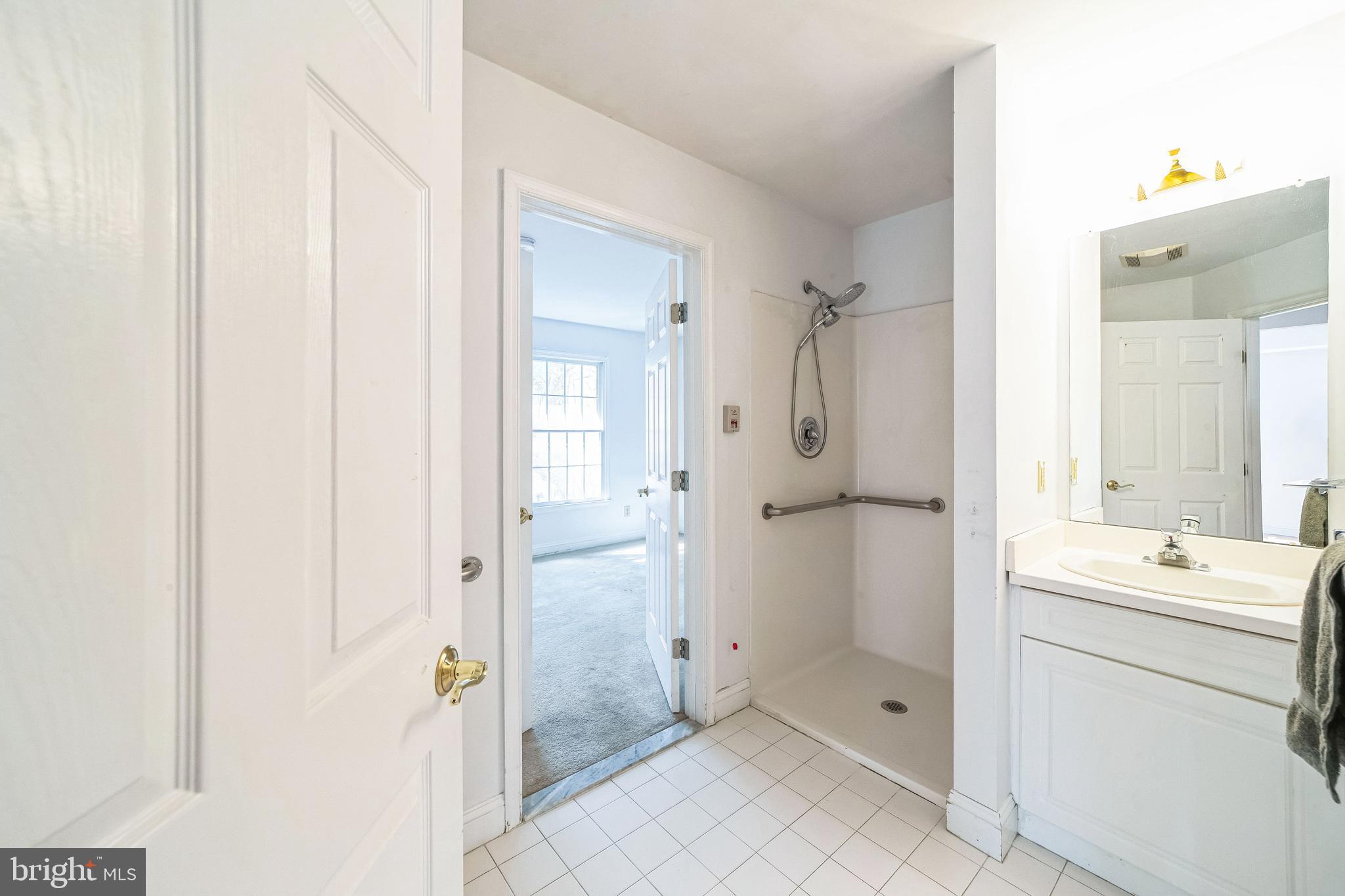 45 Hedge Row Road Princeton, NJ 08540 - Photo 12 of 24 a bathroom with a shower sink and mirror