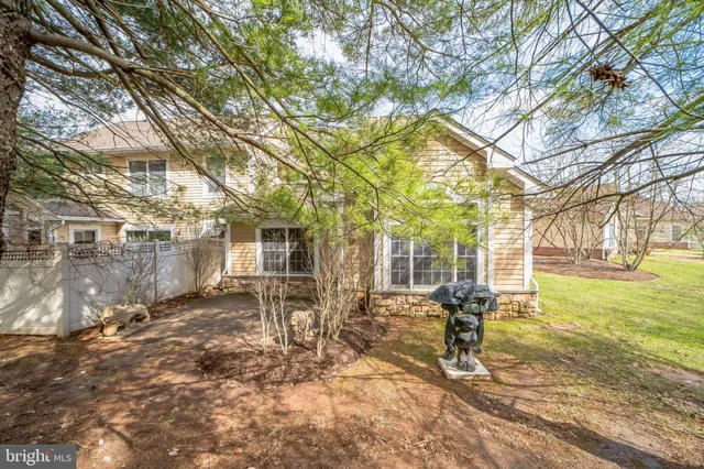 a view of a house with a yard covered in snow