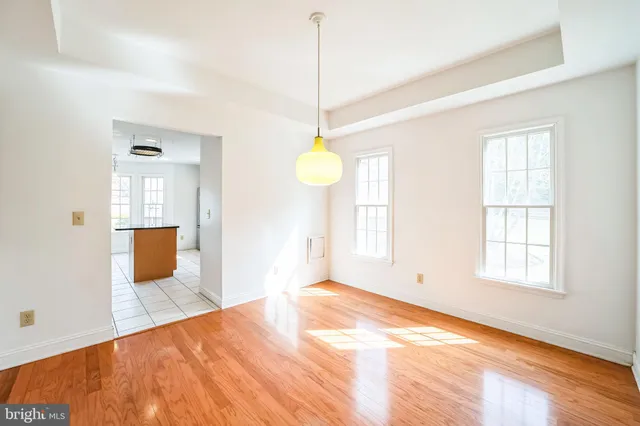 a view of a room with wooden floor and windows