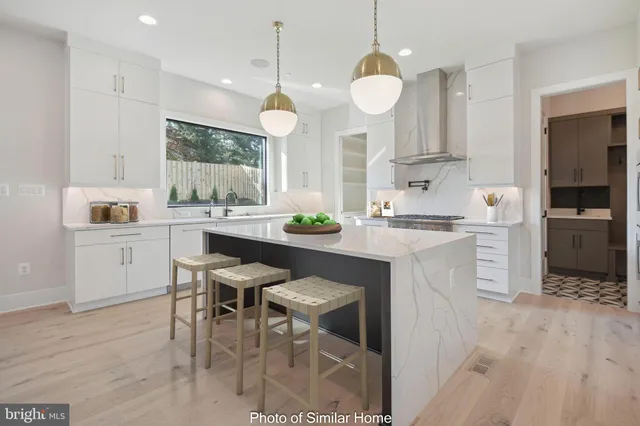 a kitchen with cabinets a sink and appliances