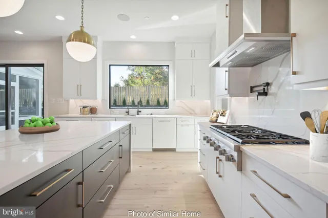 a kitchen with stainless steel appliances granite countertop a sink stove and cabinets